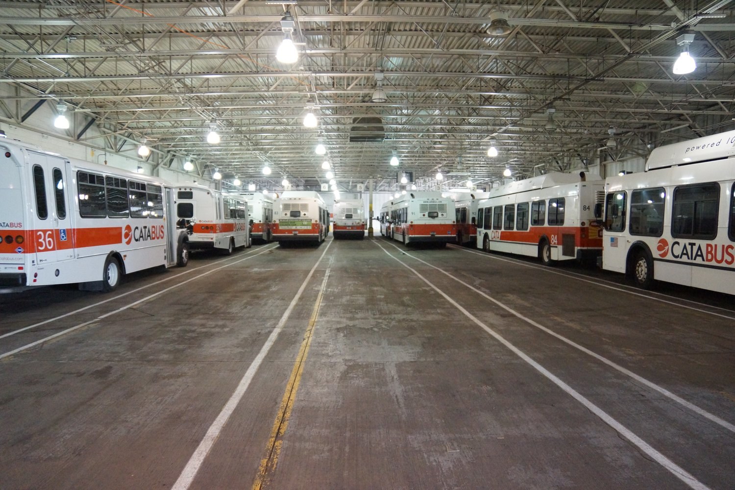 Transit buses parked inside a bus garage