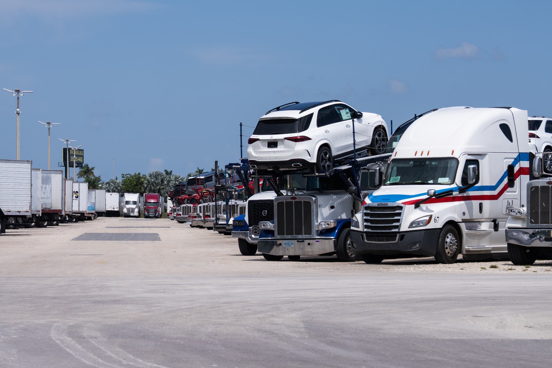 Truck parking area with tractor trailers and auto haulers